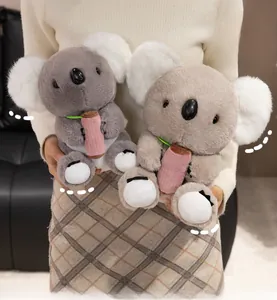 Detail of plush koala dolls in grey and brown with soft fur texture and cute accessories