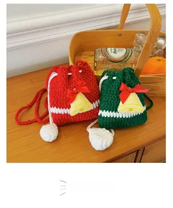 Detailed macro view of handmade Christmas reindeer crochet drawstring bags in red and green