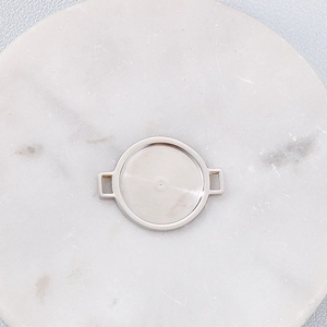 Silver stainless steel round bezel connector for jewelry making on marble tray