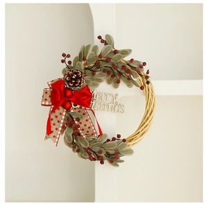 Detail of Christmas wreath with pine cones, red berries and wooden Merry Christmas sign
