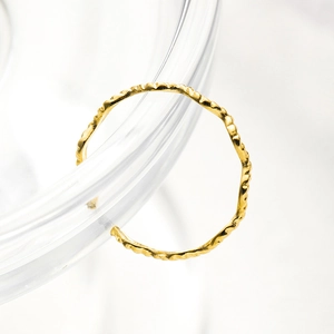 Macro shot of 18K gold plated stainless steel ring with hammered texture detail