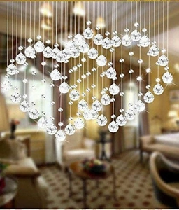 Macro detail of clear crystal beads and teardrop pendants arranged in a heart shape