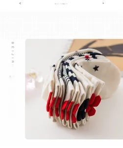 Close-up of cotton boat socks featuring blue stripes and red 3D bow details on the heel