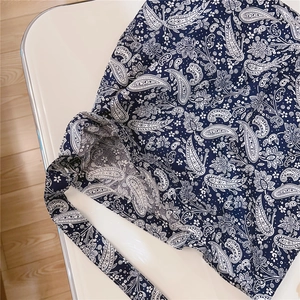 Detailed view of the dark blue paisley pattern on thick canvas fabric tote bag