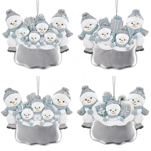 Christmas snowman family ornaments with glitter finish in white and blue hues