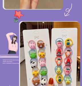 Detail of colorful cartoon elastic hair bands set with fruit and animal motifs on cards