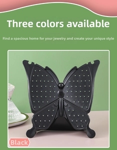Detail of black butterfly earring display stand with multi-hole design for jewelry storage