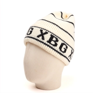 Detailed close-up of thick ribbed knit hat with black stripes and XBG knit pattern