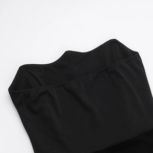 Close-up of velvet splicing and stitching detail on a black tube top dress