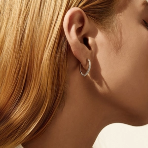 Elegant S925 sterling silver hoop earrings with moissanite pavé on a female model