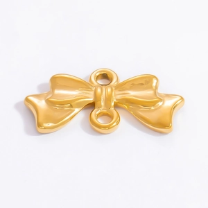 Macro view of a polished 18k gold-plated stainless steel bow jewelry connector pendant