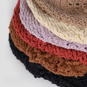 Detail of colorful handmade crochet knit hats with hollow texture and vintage tassel flowers