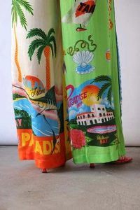 Detail of tropical island print wide leg pants with green and orange floral patterns