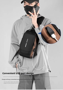 Detail view of water-resistant men's chest bag featuring an external USB charging port