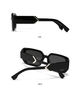 Detail view of black square sunglasses with silver arrow metal décor on side and back