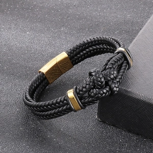 Minimalist black braided leather bracelet with golden magnetic clasp and knot detail