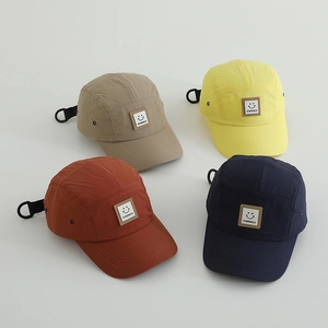 Assorted quick-dry nylon outdoor caps in khaki, yellow, rust, and blue with smile patch