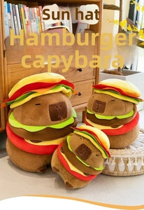 Three different sizes of creative Capybara burger plush toys in a cozy home setting