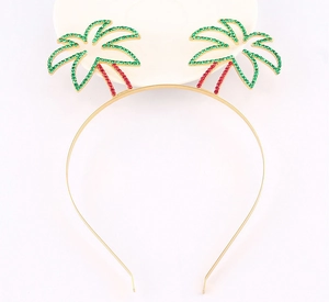 Detail of a gold headband featuring palm trees with green and red sparkling rhinestones