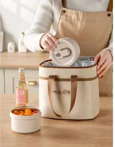Close-up of insulated lunch bag with thick aluminum foil lining and a round meal box