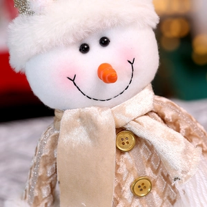 Sitting snowman doll in champagne gold outfit with white fur hat for Christmas decor