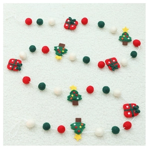 Detail of wool felt Christmas ornaments with colorful balls and tree shapes on rope