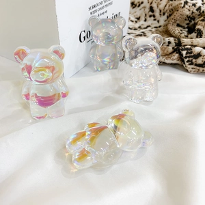 Detailed close-up of iridescent laser-coated bear phone grip with holographic resin finish