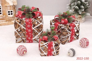 Detailed view of woven rattan Christmas gift boxes with red bows and pine cones