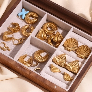 Polished 18K gold plated hollow triangle and geometric earrings set in a wooden jewelry box