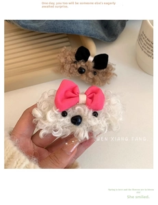Close-up of cute plush puppy hair clips with soft lamb wool texture and sweet bow details