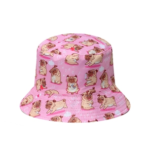 Detail of pink bucket hat featuring cute cartoon pug illustrations and music symbols