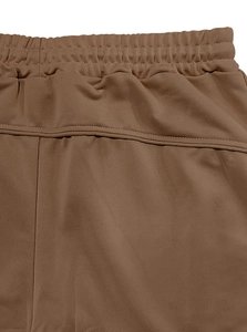 Detail of brown joggers elastic waistband featuring high-quality stitching and fabric texture