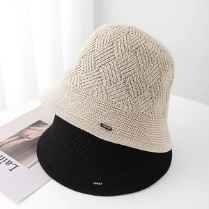 Minimalist knit bucket hat for women in beige and black with geometric textured pattern
