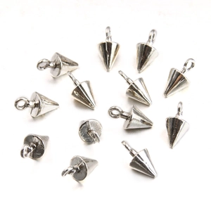 Polished silver alloy solid cone charms for DIY jewelry and keychains scattered on white background