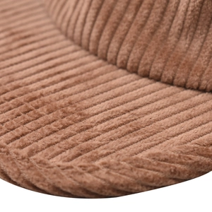 Close-up of brown corduroy fabric texture and stitching on a short brim baseball cap