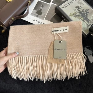 Close-up of beige pashmina scarf with twill weave texture and elegant fringe details