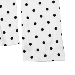 Close-up of the black polka dot pattern on white chiffon fabric with delicate hem stitching