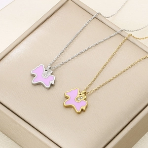 Detail of gold and silver unicorn necklaces with pink enamel and sparkling rhinestones
