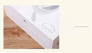 Detail of the reinforced glued bottom and 3D cut structure of the white gift bag