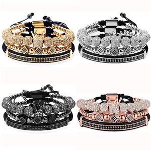 Detail view showing four sets of multilayer beaded bracelets with crowns in gold and silver