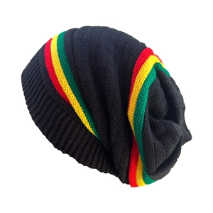 Detail of Rasta style knit beanie with red yellow and green stripes on black texture