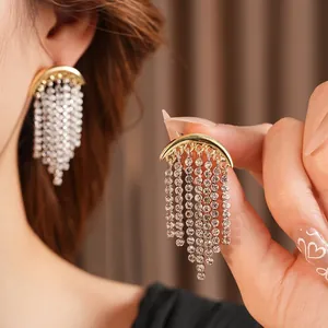 Elegant gold-tone crescent moon earrings with shimmering rhinestone tassel chains for women