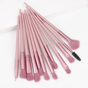 Detail view of 12-piece pink eye makeup brush set arranged in a fan shape on white