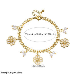 Golden double-layer chain bracelet featuring white enamel camellia and pearl accents