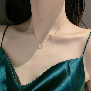 Elegant 18K gold plated titanium steel double butterfly pendant necklace on a woman's neck