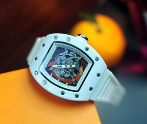 Macro shot of skeleton dial and white tonneau case with visible mechanical movement