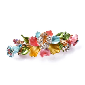 Detailed macro view of vintage metal butterfly hair clip with colorful enamel and crystals