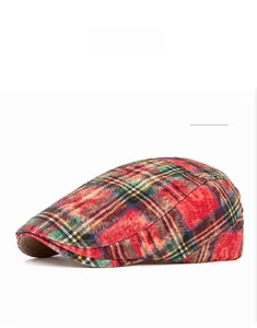 Detail of red Scottish plaid flat cap with vintage washed cotton twill fabric
