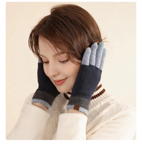 Close-up of wool touch screen gloves featuring a blue and grey gradient knit design