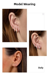Close-up of gold and silver huggie earrings with micro-pave crystals on the ear